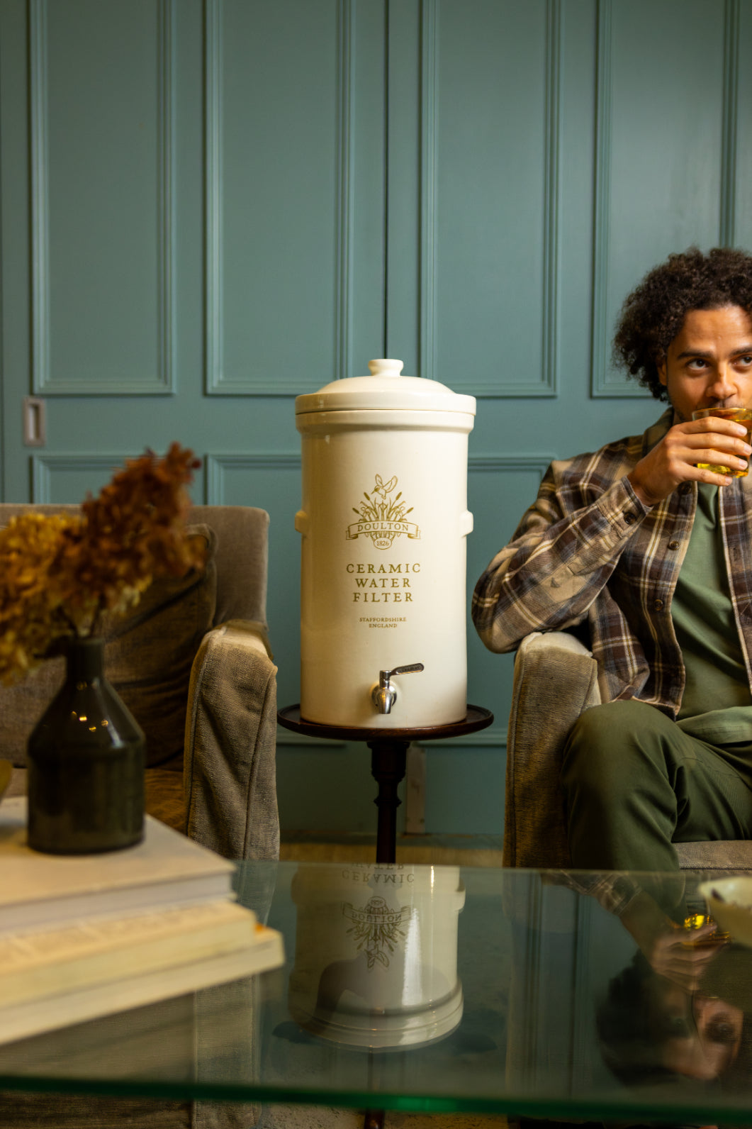 man drinking water from a ceramic water filter