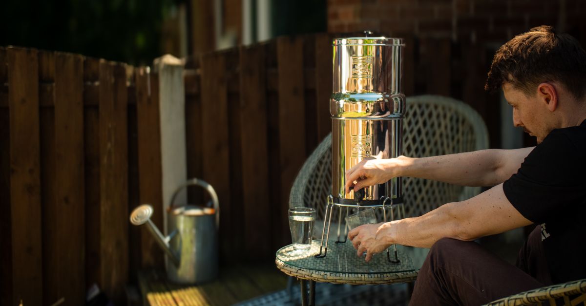  man filing up a cup with a gravity system 