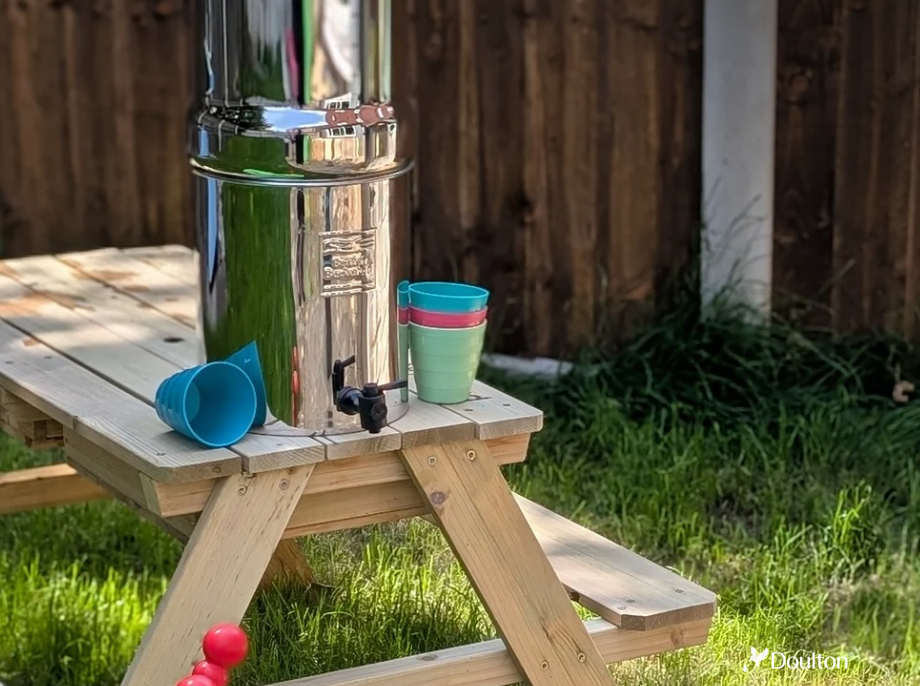 An image of a gravity water system on a picnic table 