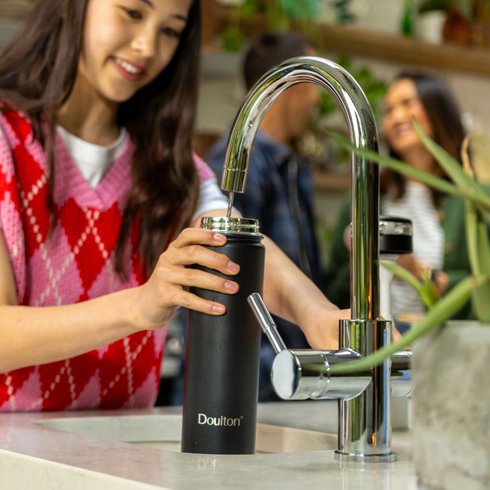 A girl filing up her taste 2 water bottle 