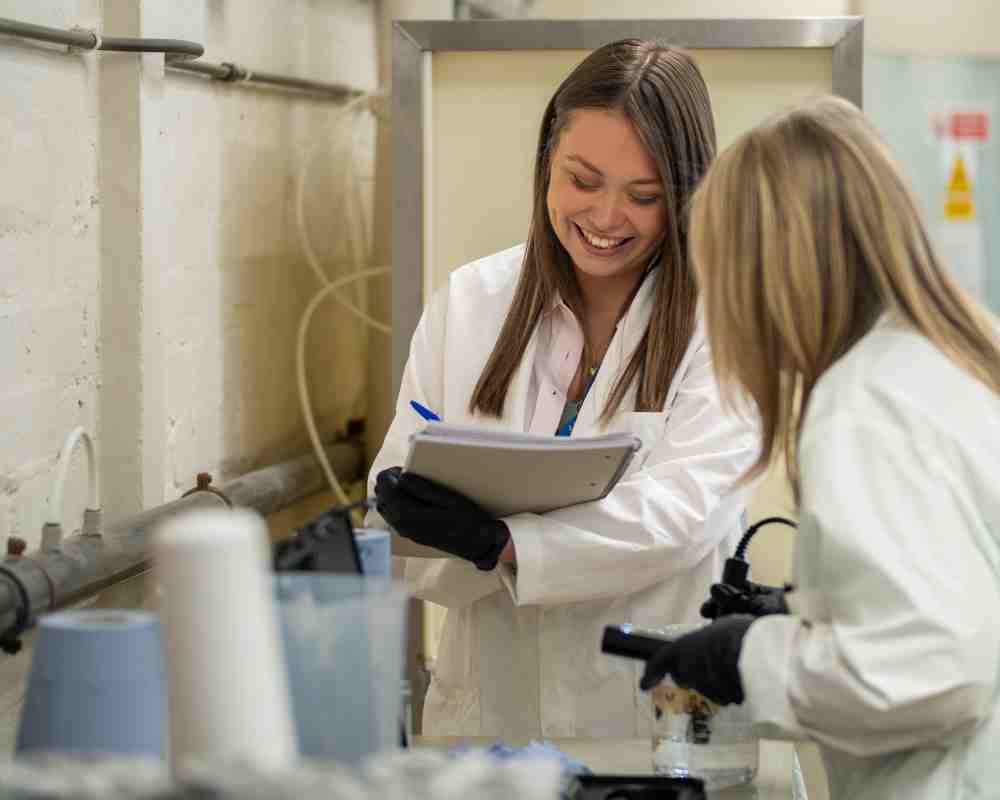 two females in lab testing water filters