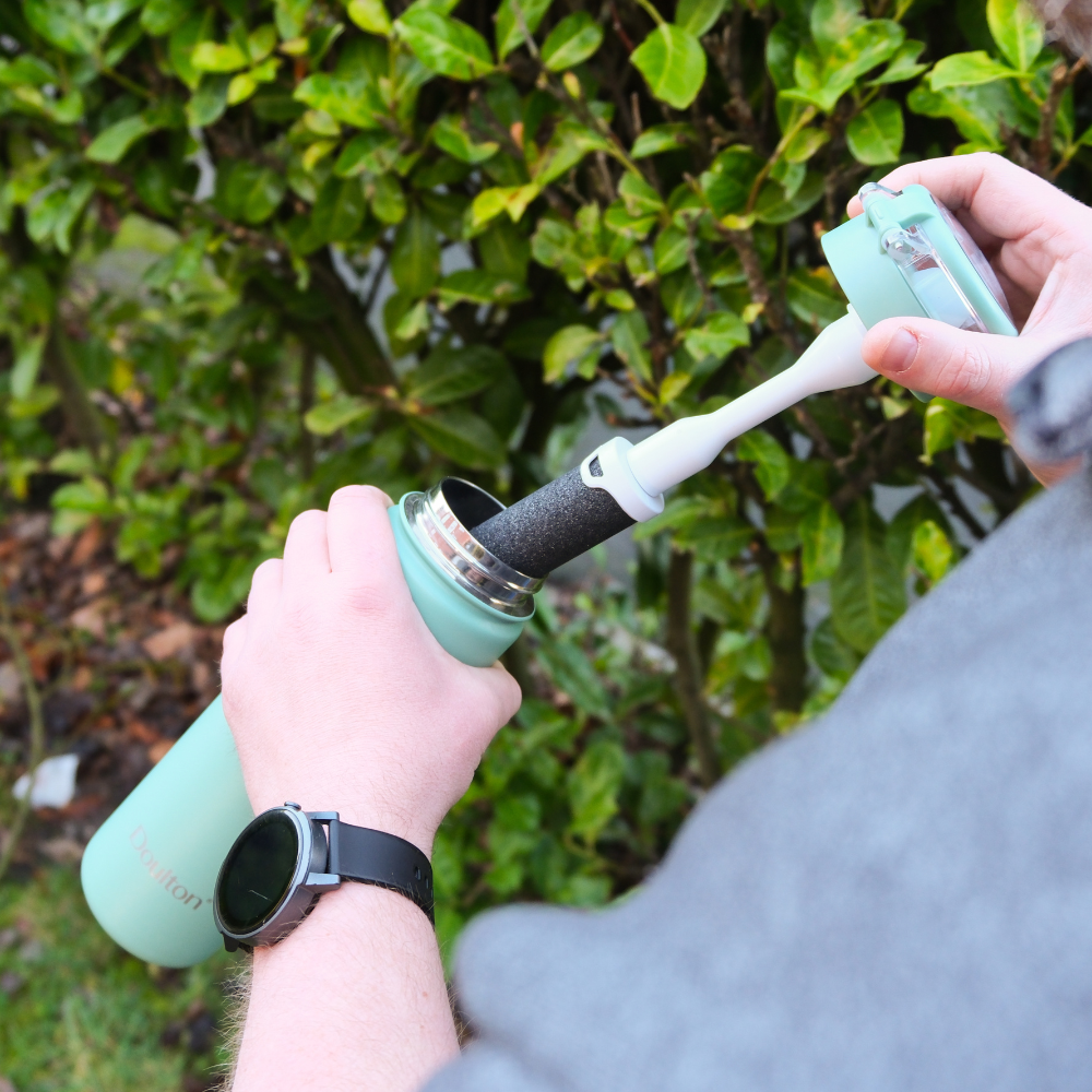 Hands holding the green Doulton Water Bottle with FIlter