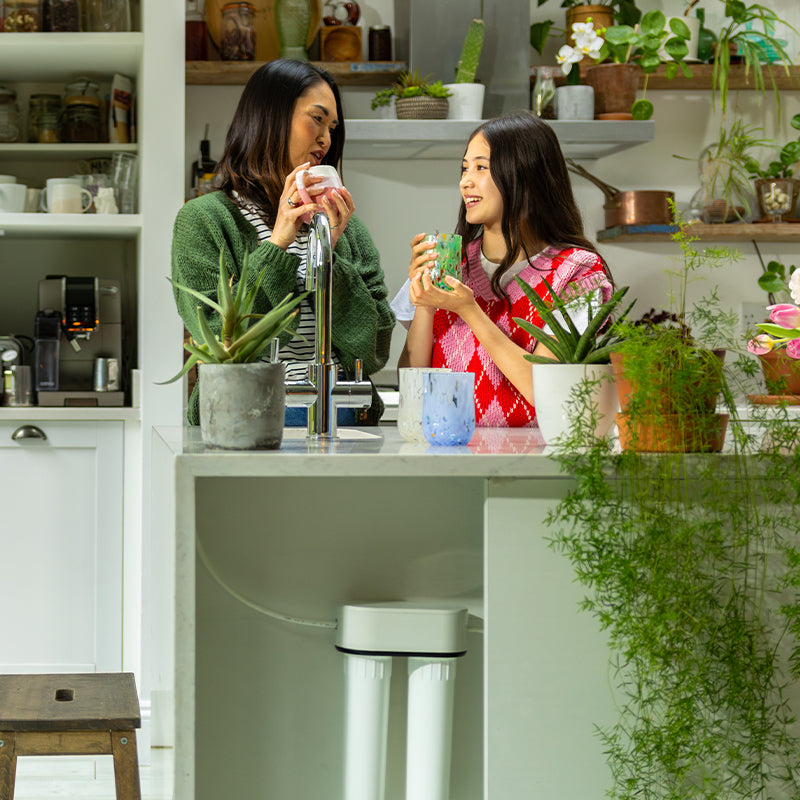Mother and daughter having a drink